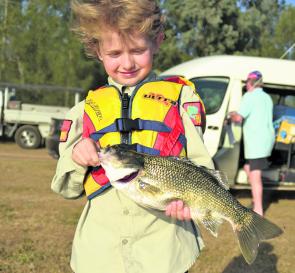 Riley, grandson of Pete and Carol from Glenbawn Kiosk, with a beaut bass he caught during a recent family fishing comp.