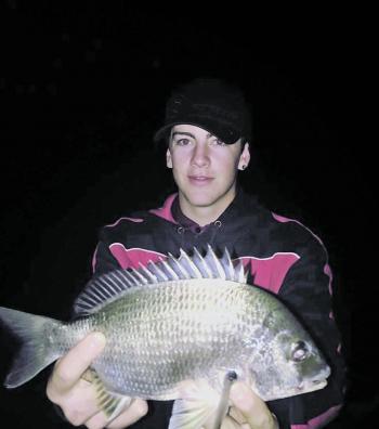 Jordan Kelly with a bream caught at night off the Redland Bay jetty.